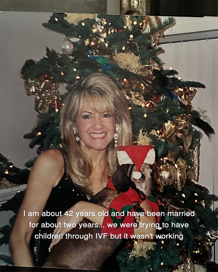 Woman smiling by decorated Christmas tree holding dog, showing aging progress and facelift results at 70 years old.