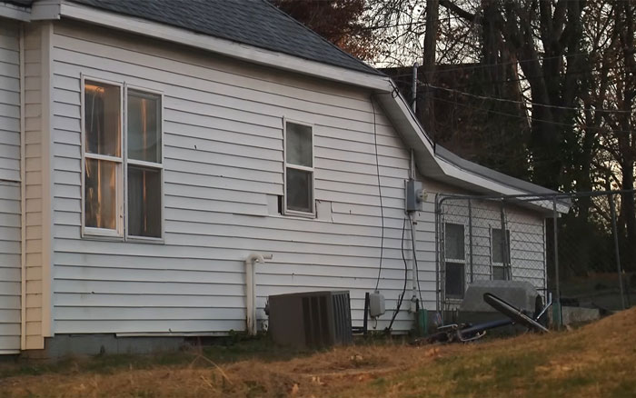 Exterior view of a white house at dusk, relevant to step-uncle arrested after 14YO girl’s body found in RV case. Exterior view of a white house at dusk, relevant to step-uncle arrested after 14YO girl’s body found in RV case.