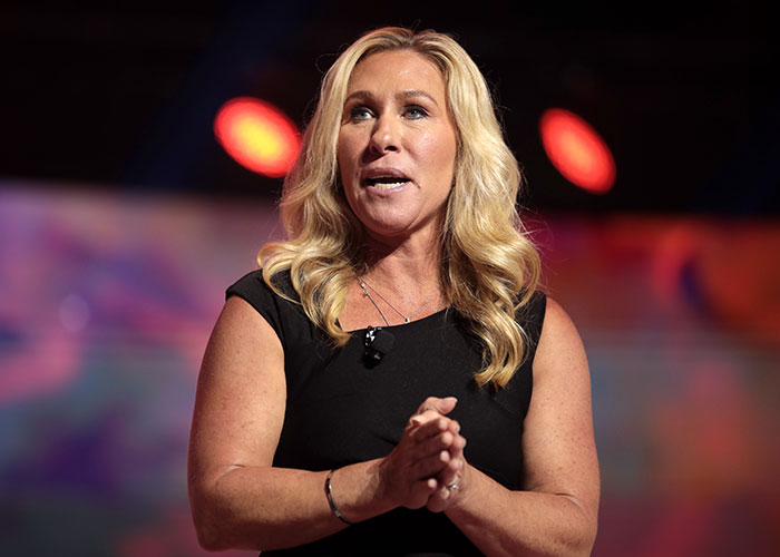 Woman with long blonde hair speaking on stage, addressing Paris Hilton Epstein rumors related to controversial Maxwell photo. Woman with long blonde hair speaking on stage, addressing Paris Hilton Epstein rumors related to controversial Maxwell photo.