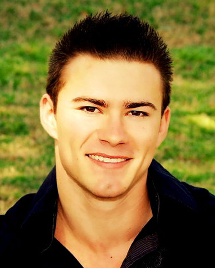 Young man smiling outdoors with text about mom claiming she discovered her son's skinned body on display in Las Vegas museum.