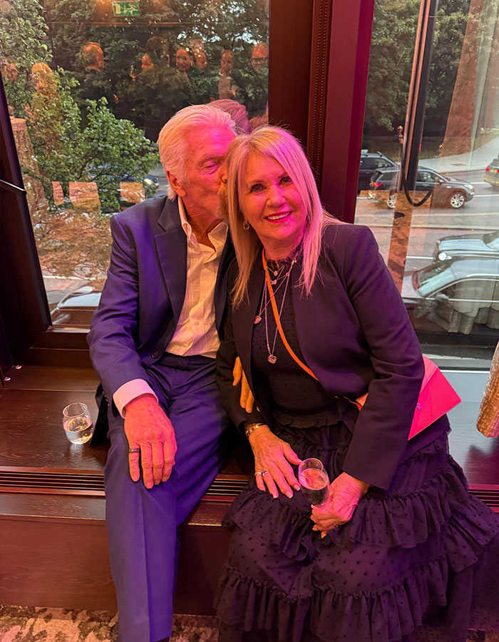 Richard Branson with his wife Joan sharing a tender moment indoors, highlighting a heartbreaking statement about her passing.