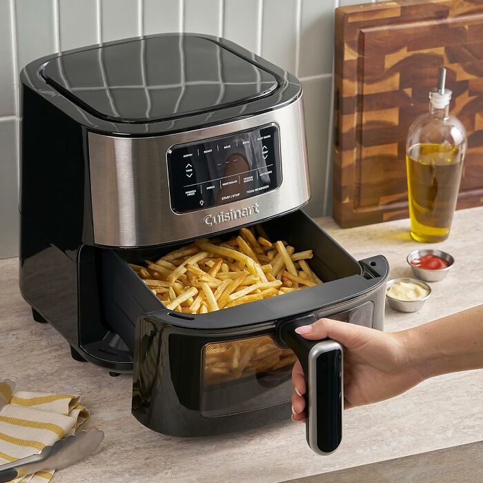 Cuisinart air fryer with crispy French fries inside, a popular main character splurge during Black Friday week.