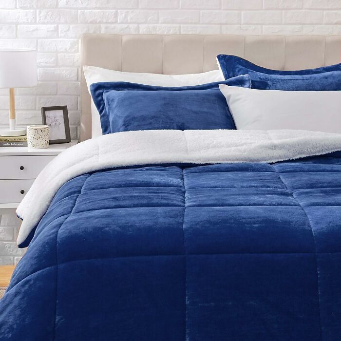 Blue plush comforter and pillows on bed in modern bedroom, perfect Black Friday deals for cozy home essentials.