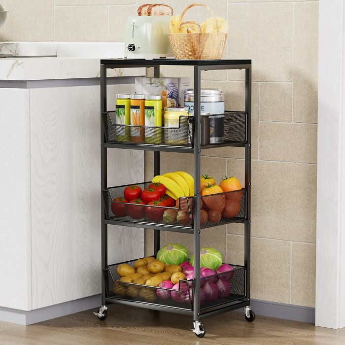 Black Friday kitchen deals featuring a black metal storage cart with fresh produce and pantry items on wheels.