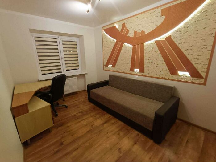 Minimalist small room with desk, office chair, and couch, example from wild real estate listings to sell properties.