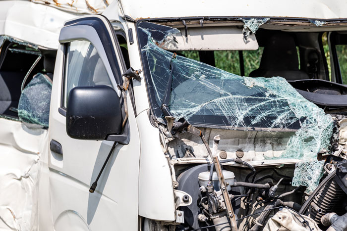 White van with shattered windshield and severe front-end damage after a crash illustrating stories of people who don’t deserve nice things