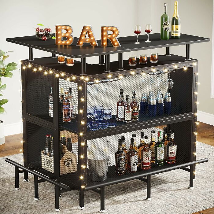 Black Friday kitchen deals featuring a modern home bar setup with liquor bottles, glasses, and decorative lights.