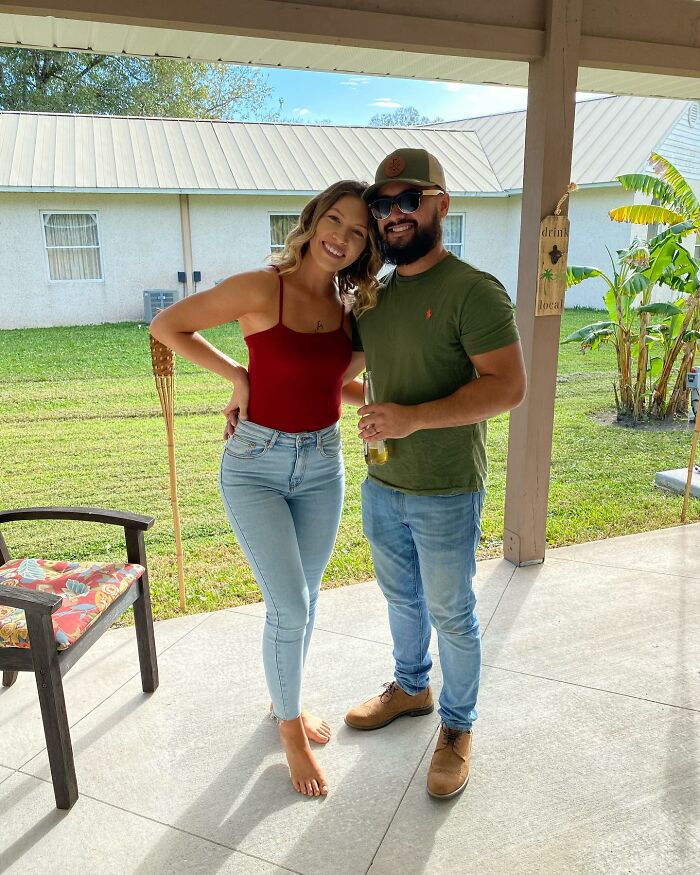 Couple standing outdoors on porch, smiling and posing together, linked to story about saving butterfly with broken wing.