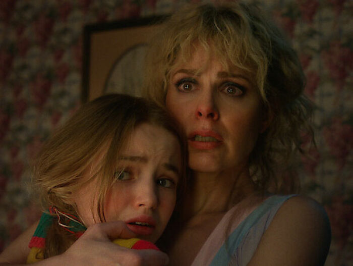 Stranger Things star revealing bullying faced by Millie Bobby Brown, showing emotional support and concern in a tense moment.