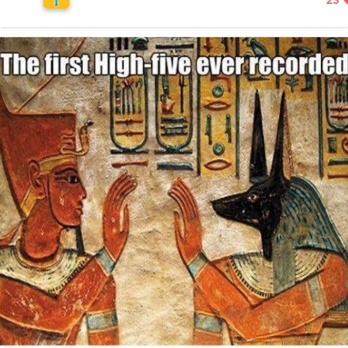 Ancient Egypt meme showing two figures giving the first high-five with hieroglyphics in the background.