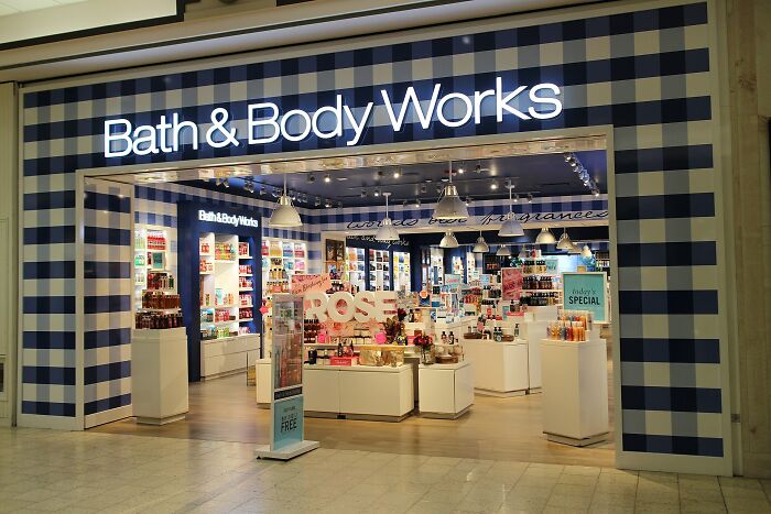 Bath & Body Works store entrance with displays of scented products during Black Friday shopping event.