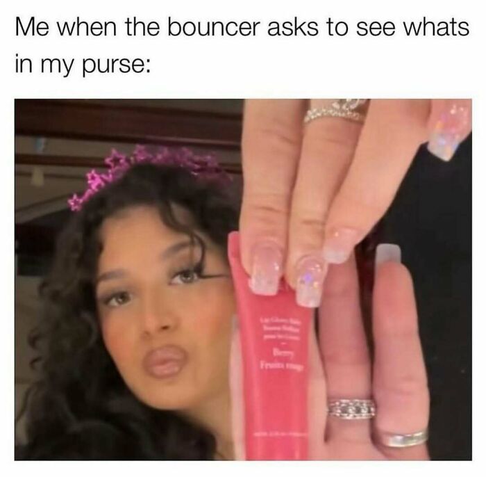Young woman with styled hair and manicured nails holding a makeup product, humorously reacting to purse inspection meme about fashion.