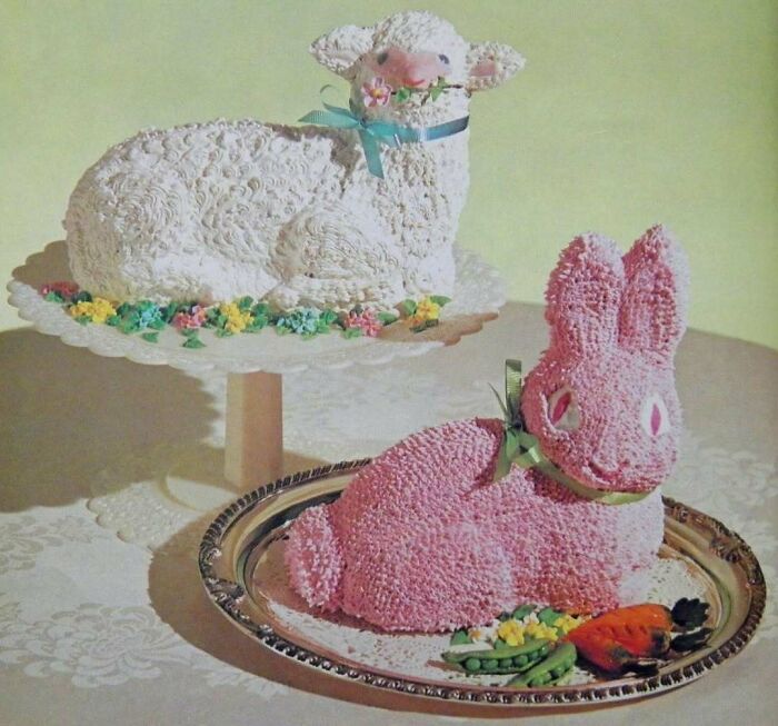 Vintage creative cakes shaped like a lamb and a pink bunny on decorative platters, showcasing disturbingly creative vintage recipes.