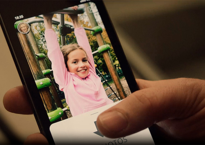 Close-up of a person holding a phone showing a child’s photo, highlighting why parents shouldn’t post about their children online. Close-up of a person holding a phone showing a child’s photo, highlighting why parents shouldn’t post about their children online.