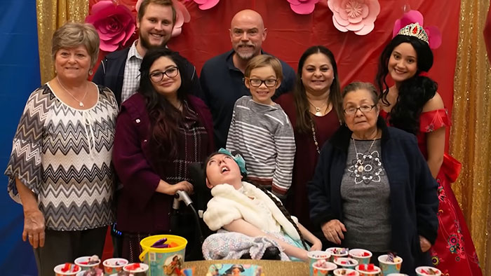 Family celebrates woman born without most of her brain on her 20th birthday, sparking a heartfelt and heated debate.