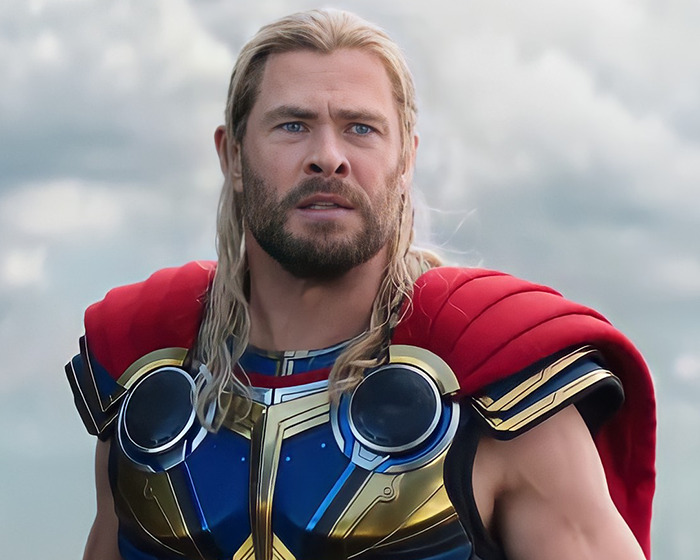 Actor in superhero costume making stunning confessions about their movies years after filming, captured in dramatic scene.