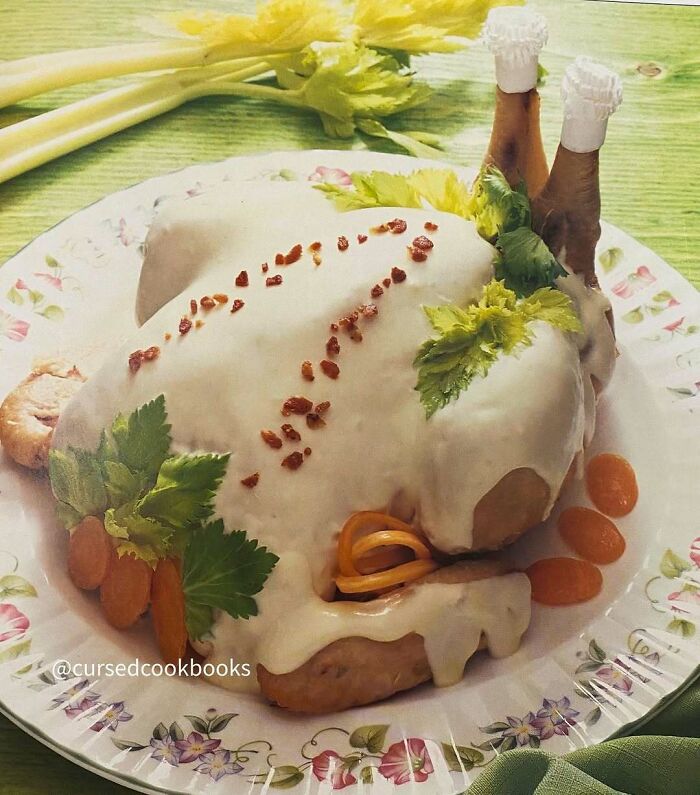 Vintage recipe of a molded chicken covered in creamy white sauce, garnished with celery leaves and small carrot slices.