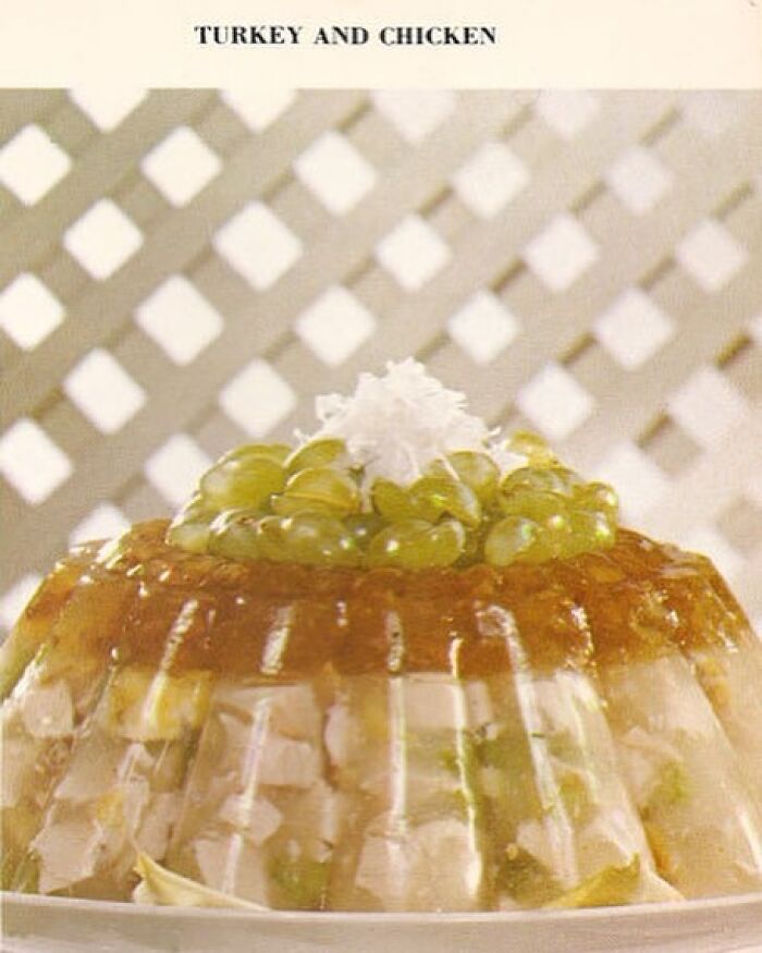 Vintage turkey and chicken gelatin mold topped with grapes and coconut, showcasing disturbing creative vintage recipes from Gen X era.