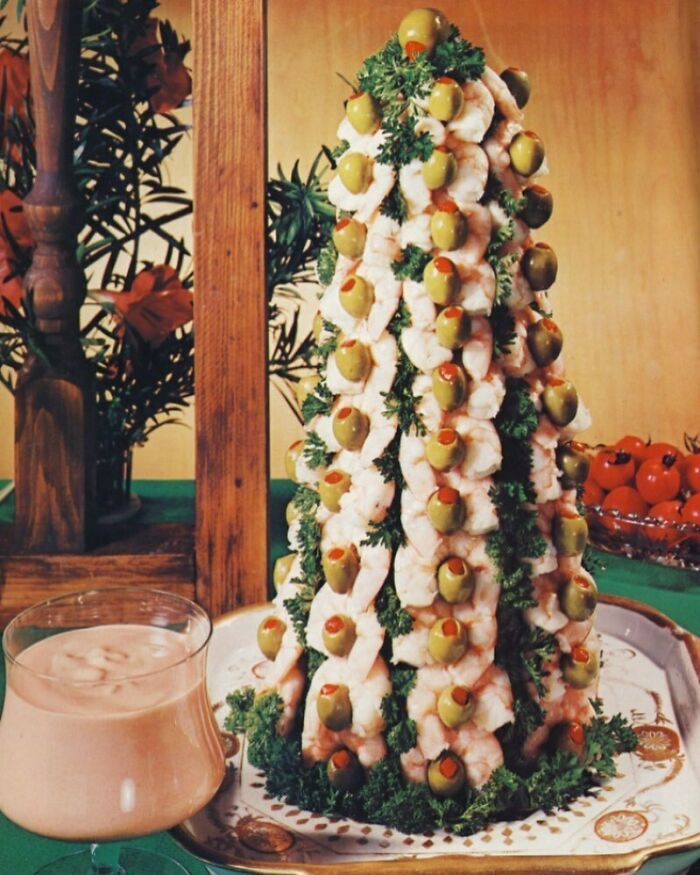 Vintage shrimp and olive tower with cocktail sauce and parsley, showcasing disturbingly creative vintage recipes from Gen X era.