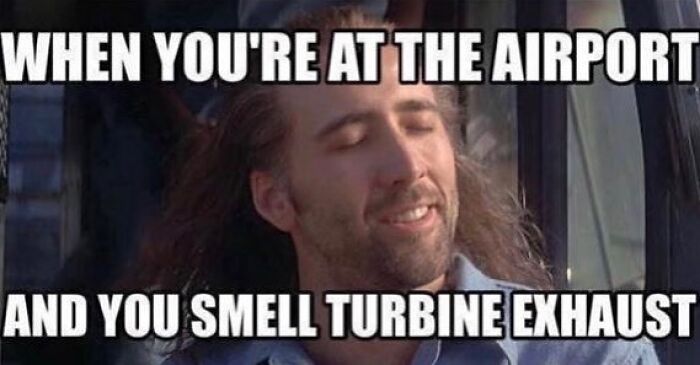 Man smiling with eyes closed enjoying the smell of turbine exhaust at the airport aviation memes concept.