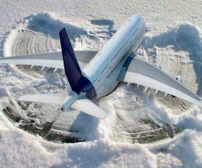 Airplane model placed in snow with wing and body imprints, showcasing aviation humor for aviation memes fans.