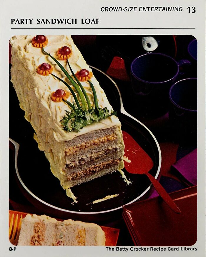 Vintage party sandwich loaf with layered fillings and decorative garnishes, a classic creative vintage recipe from Gen X era.