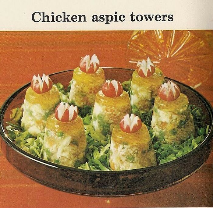 Vintage chicken aspic towers on a bed of lettuce showcasing creative vintage recipes from Gen X era.
