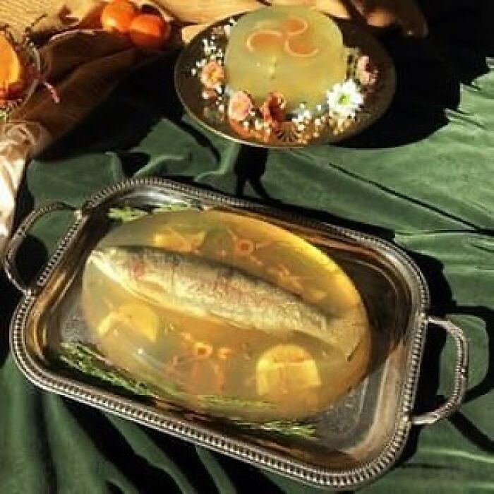 Vintage recipe gelatin mold with whole fish and lemon slices on a silver tray, showcasing creative vintage recipes.