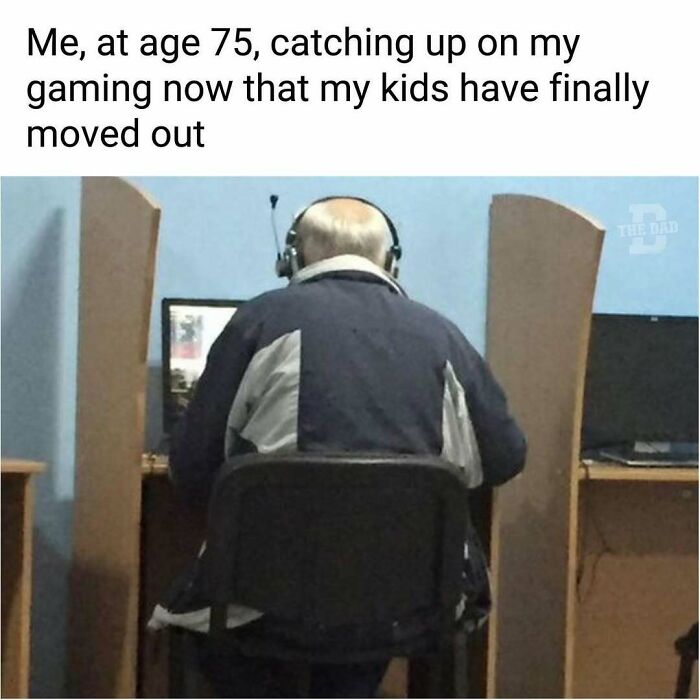 Older man wearing headphones playing video games alone, enjoying peaceful gaming time without distractions.