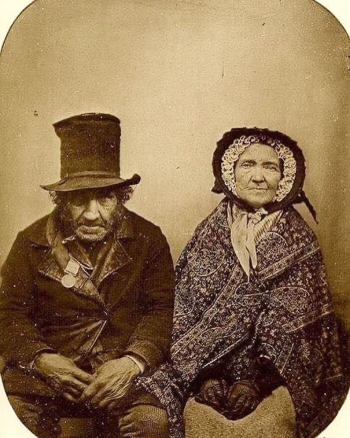 Victorian era portrait of an elderly couple in period clothing showcasing the weird photos from the Victorian era.