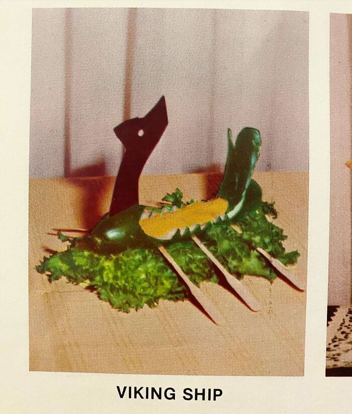 Vintage creative recipe of a Viking ship made with vegetables and lettuce, showcasing disturbingly creative vintage recipes.
