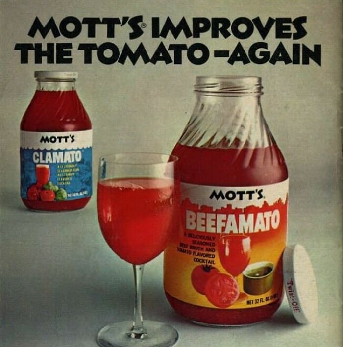 Vintage Mott's tomato-based drink bottles labeled Clamato and Beefamato with a glass of red cocktail, vintage recipe concept.