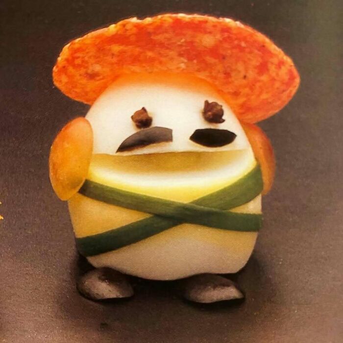 Vintage creative recipe featuring a boiled egg decorated with vegetables to resemble a character, showcasing vintage recipes.