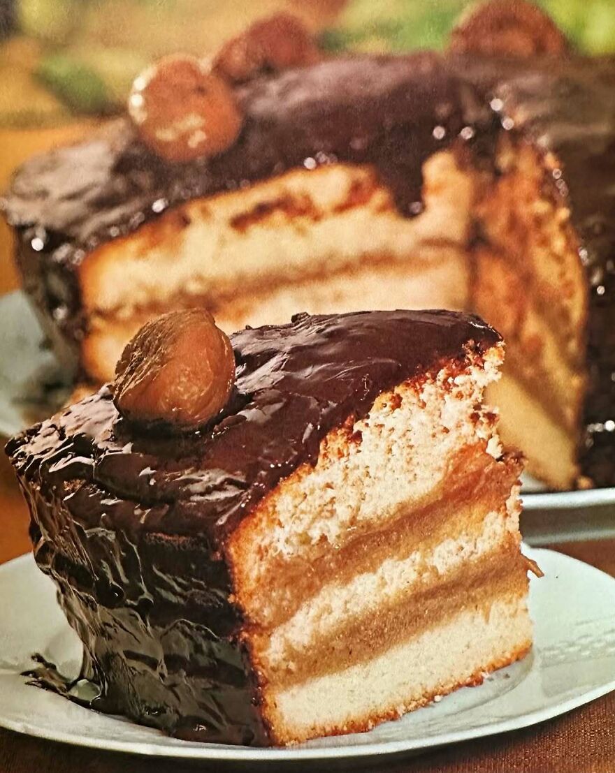 Vintage recipe cake slice with chocolate frosting and fruit topping, showcasing bizarre dishes from the past era.