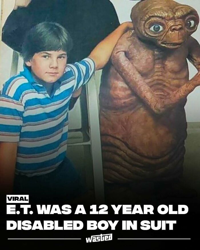 Boy in striped shirt posing with E.T. character suit, popular on a page for fun facts and new discoveries.