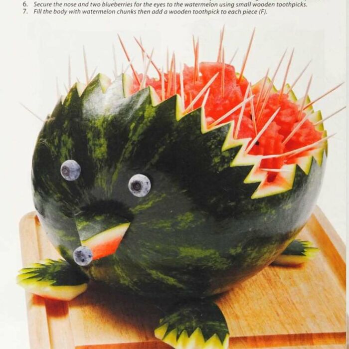 Creative vintage recipe watermelon hedgehog carved with blueberries and toothpicks, a quirky Gen X food presentation idea.