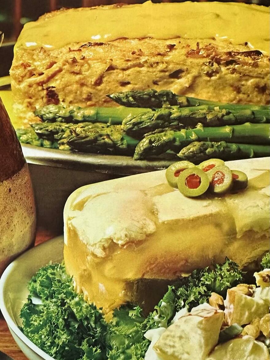 Vintage recipe dish with layered casserole, asparagus, olives, and salad showcasing interesting vintage recipes and bizarre dishes.
