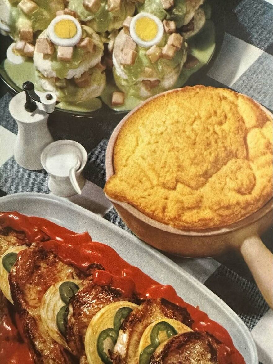 Vintage recipes plate with baked casserole, deviled eggs topped with green sauce, and sliced meat with ketchup and jalapenos.