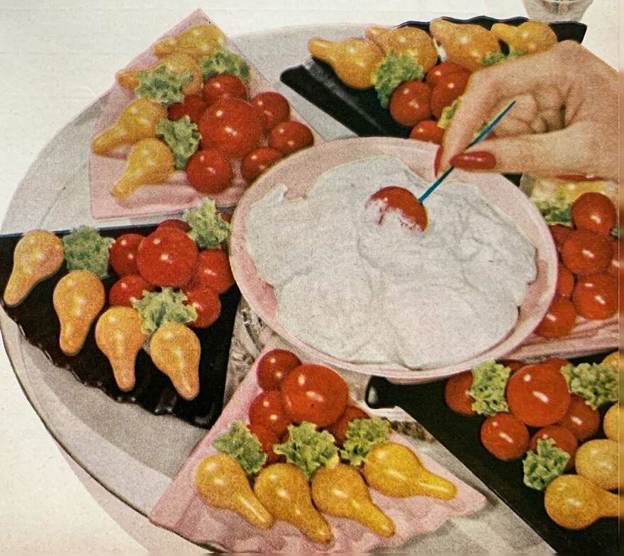 Vintage recipe platter with bizarre shaped appetizers, cherry tomatoes, lettuce, and a creamy dip being served with a toothpick.