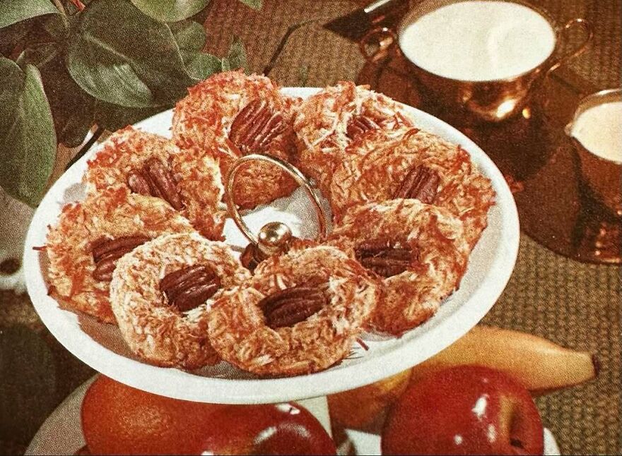 Plate of vintage pecan coconut cookies arranged on a tiered serving tray, showcasing interesting vintage recipes.
