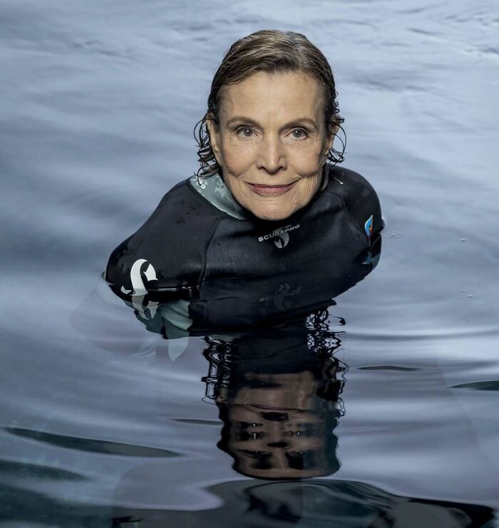 Older woman in a wetsuit floating in water, representing women overlooked in history with important achievements