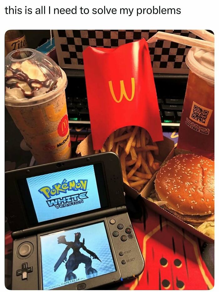 Close-up of a handheld gaming console, McDonald's fries, burger, drink, and dessert for entertaining posts and memes.