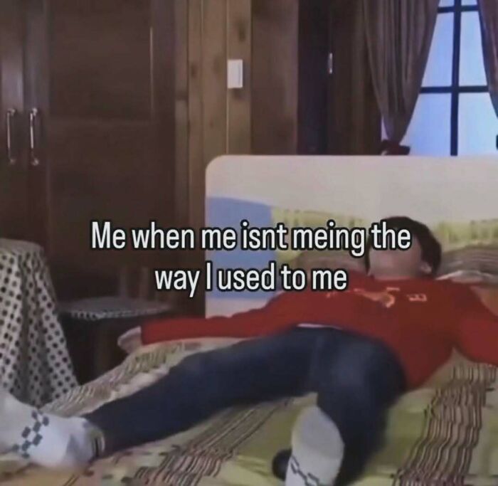 Person lying on bed in red sweater with humorous text about feeling unlike their usual self, entertaining meme to fight boredom.