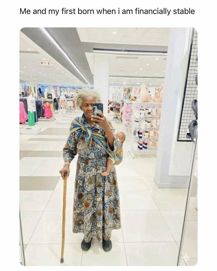 Elderly woman with a walking stick carrying a baby doll in a sling, taking a mirror selfie, entertaining post meme.