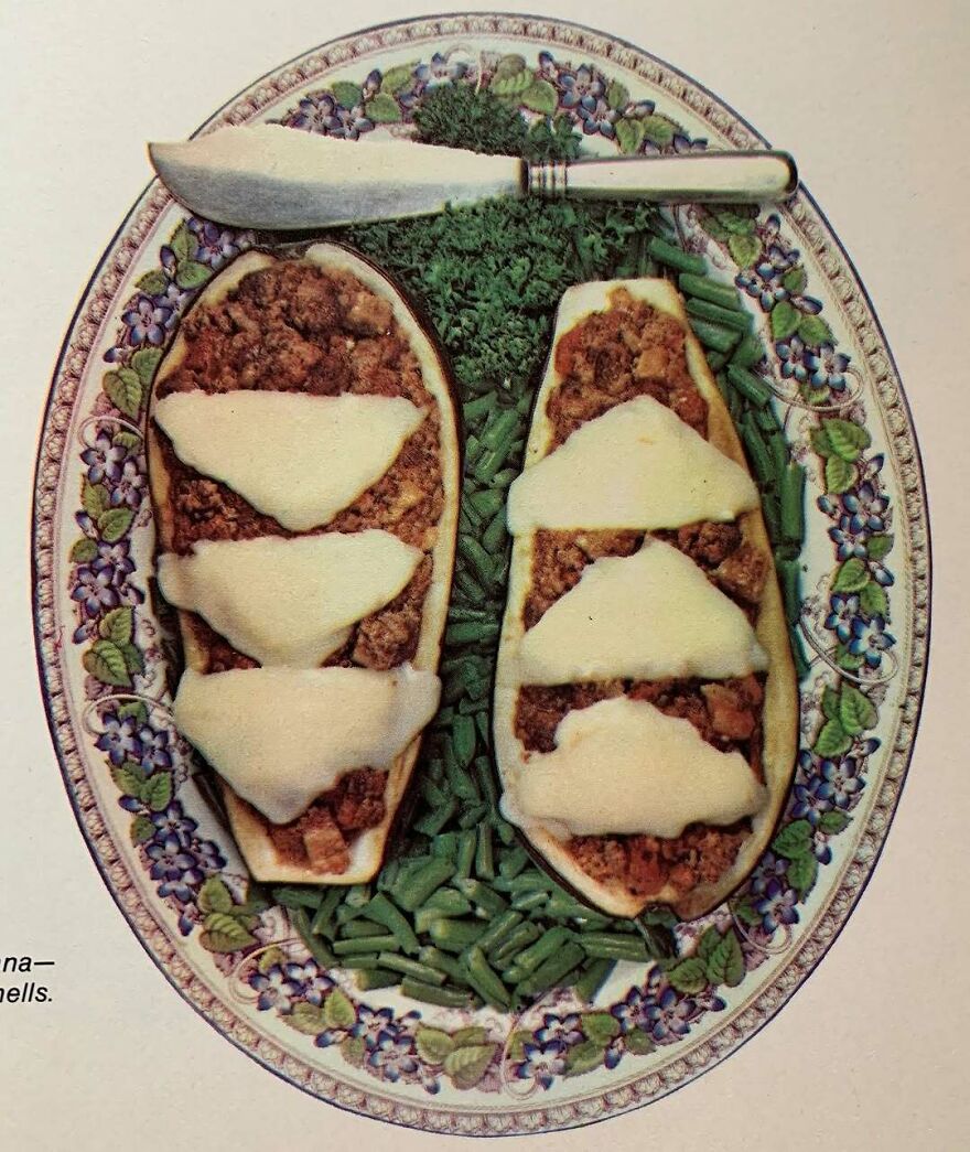 Vintage stuffed zucchini with melted cheese and green beans on a floral plate, showcasing interesting vintage recipes.