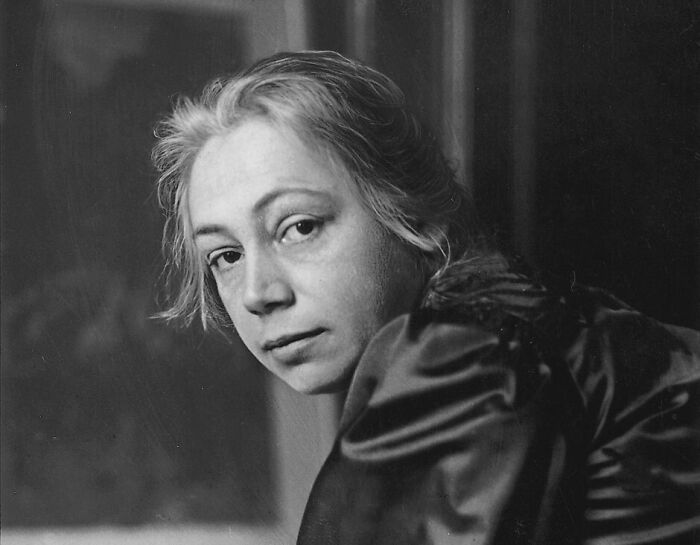 Black and white portrait of a woman in vintage clothing reflecting the overlooked women in history and their achievements.