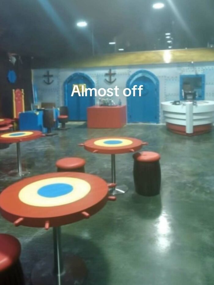 Empty room with colorful round tables and stools, creating an entertaining posts and memes vibe to fight boredom and sadness.