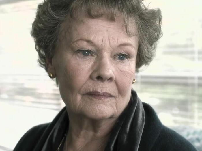Film icon Dame Judi Dench with a somber expression, sharing a heartbreaking health confession about memory struggles.