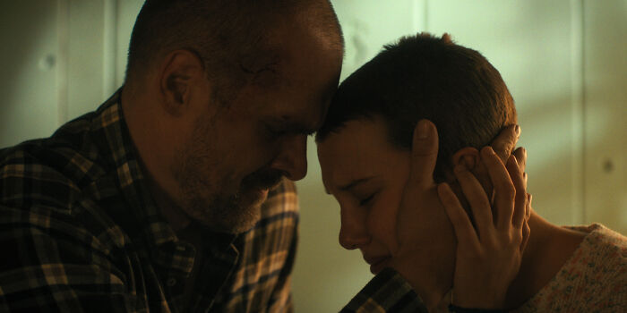 Millie Bobby Brown and David Harbour share an emotional moment in a dimly lit scene reflecting their complex relationship. Millie Bobby Brown and David Harbour share an emotional moment in a dimly lit scene reflecting their complex relationship.