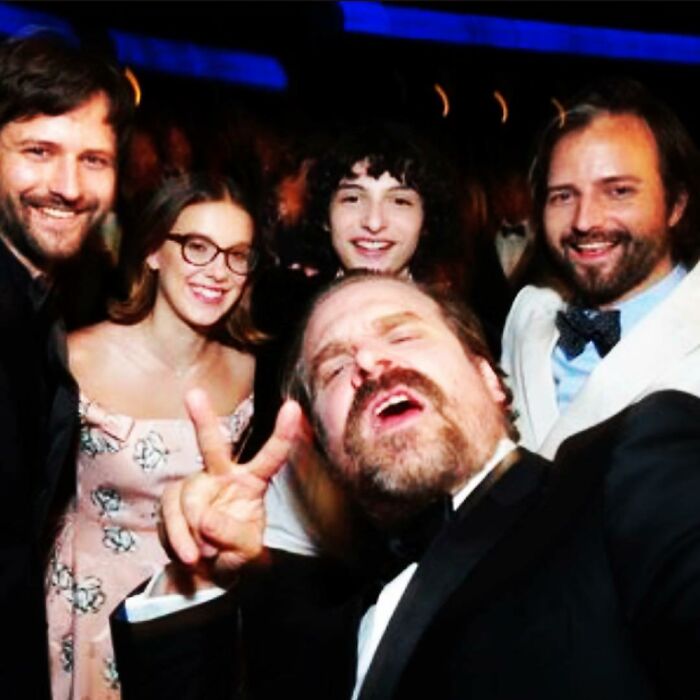 Millie Bobby Brown and David Harbour smiling with friends at an event highlighting their complex relationship amid allegations Millie Bobby Brown and David Harbour smiling with friends at an event highlighting their complex relationship amid allegations